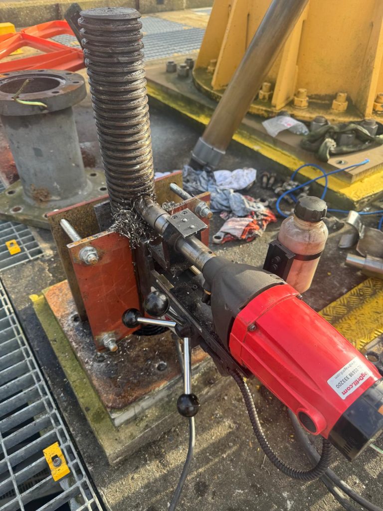 Using the custom-built jig to drill the hole for the penstock actuator spindle