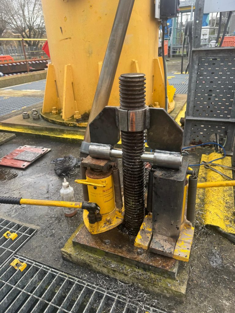 bespoke emergency penstock recovery device, including a drilling jig, lifting bar, and split load-spreading bracing gusset plates