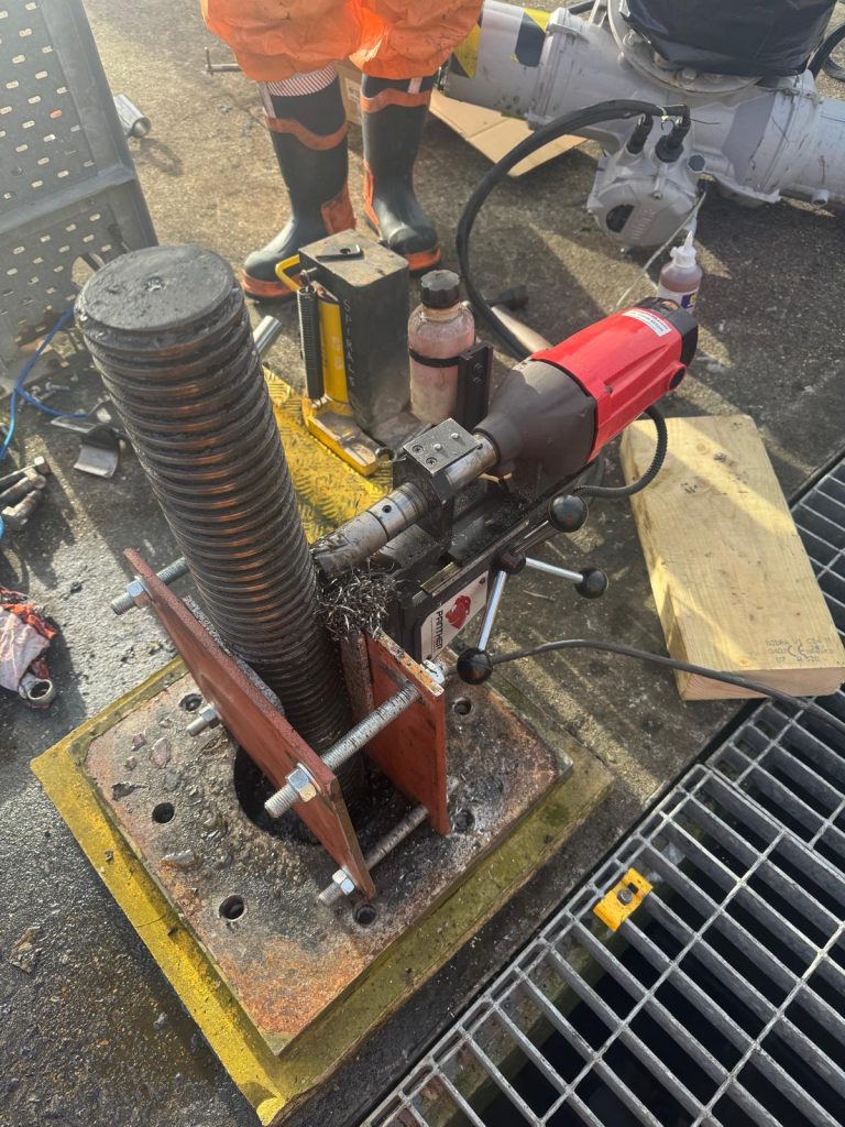 Using the custom-built jig to drill the hole for the penstock actuator spindle