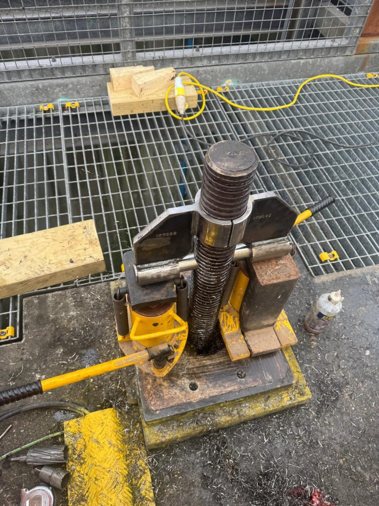 bespoke emergency penstock recovery device, including a drilling jig, lifting bar, and split load-spreading bracing gusset plates